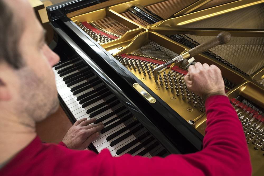 Jan Machart při ladění klavíru Steinway