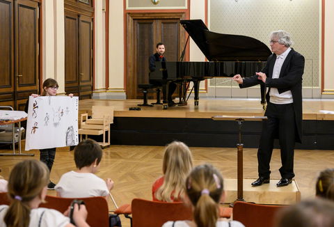Photo illustrating a concert - event A Morning with Philharmonic Musicians Hocus Pocus Conductor